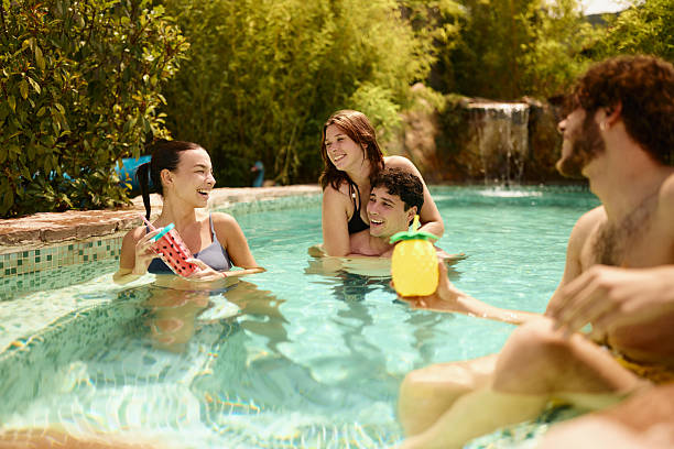 istock Young happy friends talking in the pool at the backyard. 2247748246