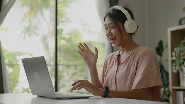 istock Asian woman working on laptop at home table. 2247748542