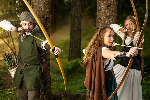 istock Young Caucasian Medieval Archers Practicing Traditional Archery Skills in Forest Setting 2247748581