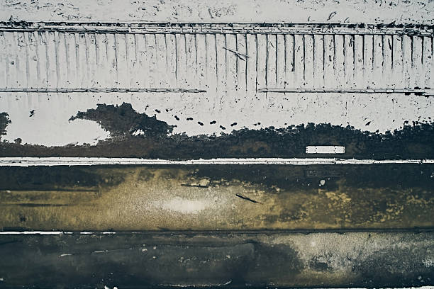 Aerial view of an abandoned wooden ship at the bottom of the river in winter, against the background of white snow and black water