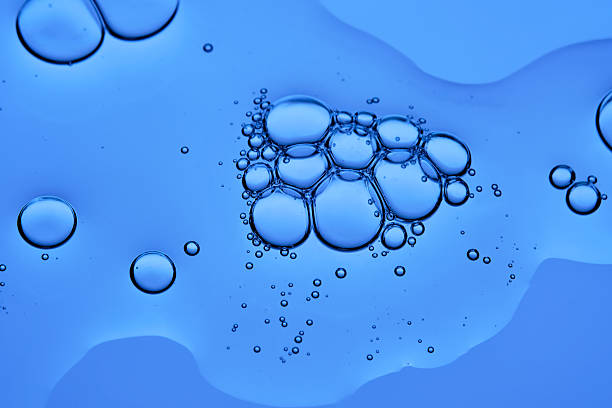 istock The texture of a cosmetic serum with bubbles on a blue background. 2247750460