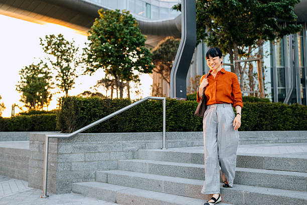 istock Smiling businesswoman walking outside office building 2247751644