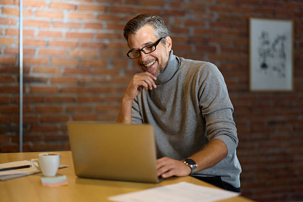 istock Happy businessman working on laptop in the office. 2247751690