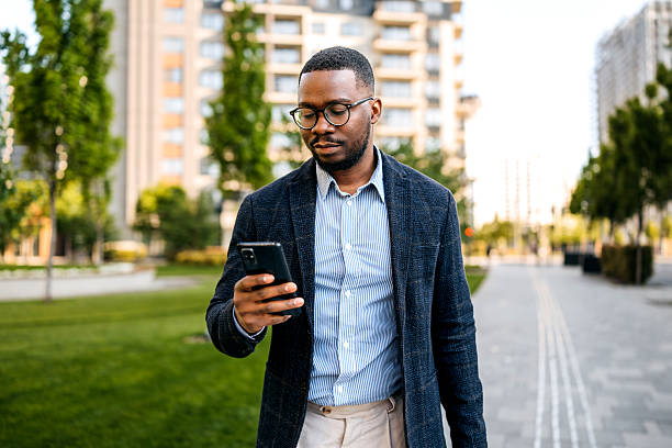 istock Well-dressed young businessman using smartphone outdoors in the city 2247751800