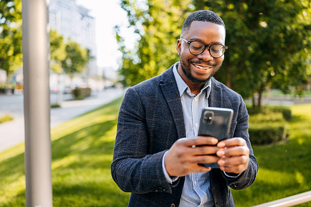 istock Well-dressed young businessman using smartphone outdoors in the city 2247751813