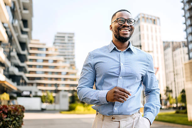 istock Smiling businessman walking at downtown district 2247752118