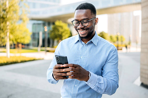 istock Cheerful businessman using smart phone outdoors 2247752190