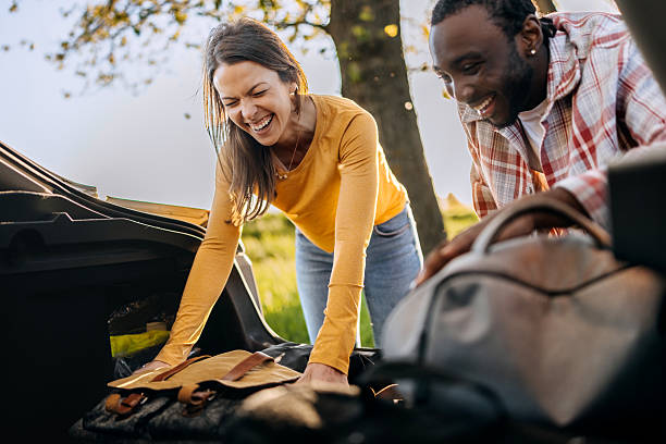 istock Couple unpacking car trunk in nature together 2247753347