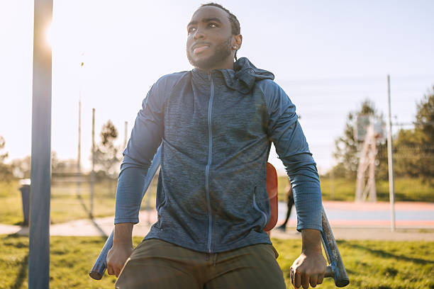 istock Young man exercising in open air gym 2247753542