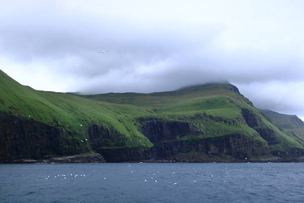 istock view to Mykines Island showcasing towering cliffs surrounded by the expansive North Atlantic Ocean, Faroe Islands, Denmark 2247754231