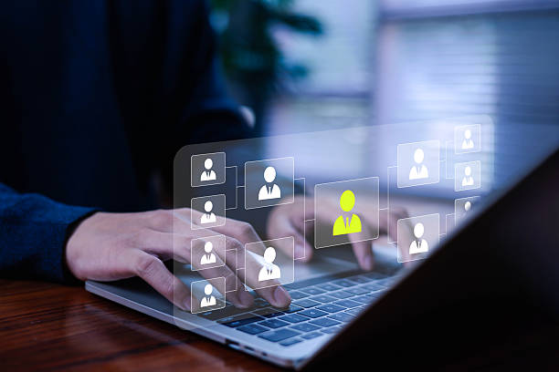 istock Business professional using a laptop with futuristic HR interface showing talent selection icons, highlighting digital recruitment, employee management, and modern human resources technology. 2247754312