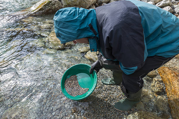 istock Gold panning, search for gold with a green gold pan 2247754628