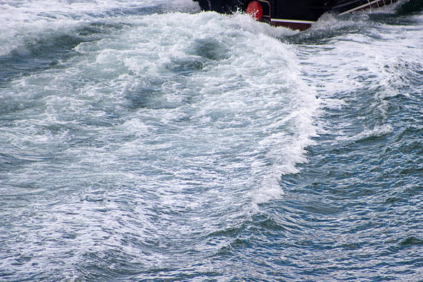 Foaming water from the side of a yacht