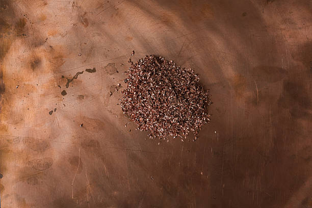 istock Pile of copper shavings on a scratched copper metal surface. 2247757171