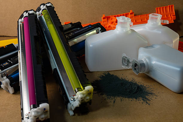 istock Colorful printer cartridges and wasted toner bottles 2247757396