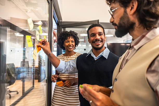 istock Diverse business team collaborating with sticky notes on glass wall 2247758902