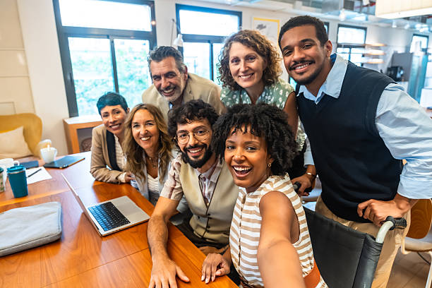 istock Diverse business team taking candid selfie in modern office 2247758970