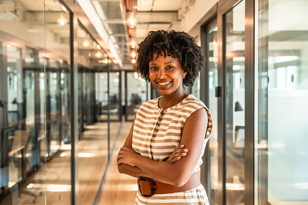 istock Confident businesswoman smiling in modern office hallway 2247758991
