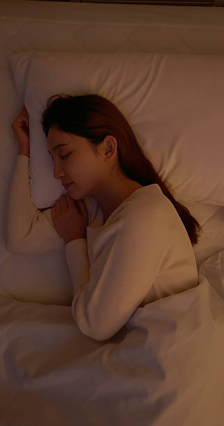 istock asian female sleeping home mobile phone aside 2247759623