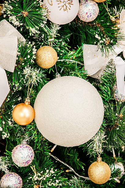 istock Elegant White and Gold Christmas Tree Decorations with Festive Bow 2247759719