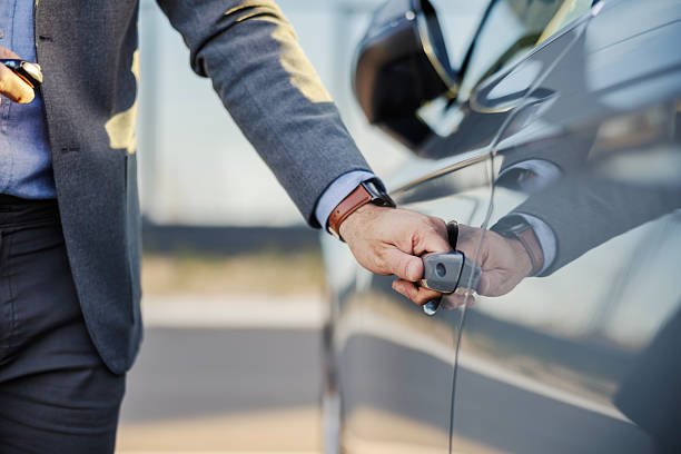 istock Businessman opening car door with smart key 2247760261