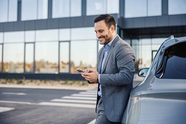 istock Businessman enjoying mobile work connectivity standing by car 2247760307