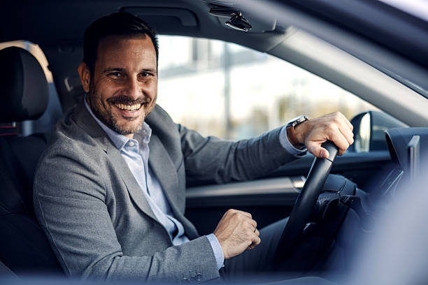 istock Smiling professional man driving car happily 2247760902