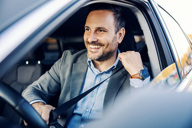 istock Happy man buckling seatbelt in car before driving 2247760907