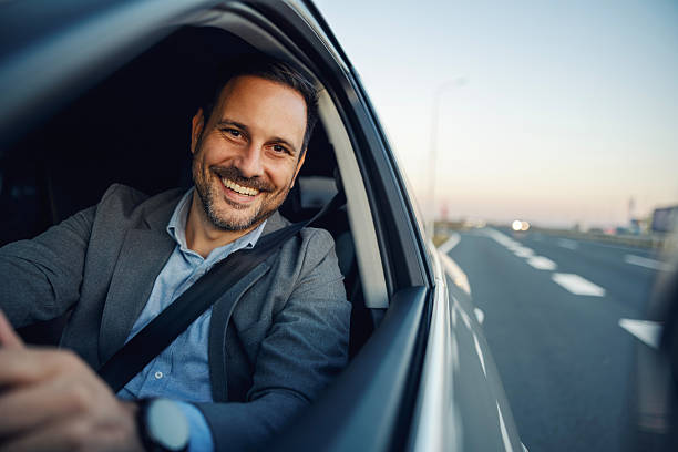 istock Happy businessman driving car on highway 2247760985