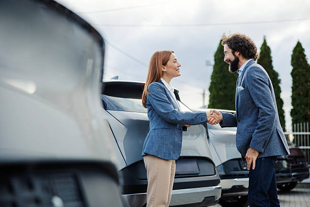 istock Car dealership agent shaking hand with male customer 2247761994