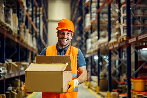 istock Warehouse worker smiling holding packages for delivery 2247764337
