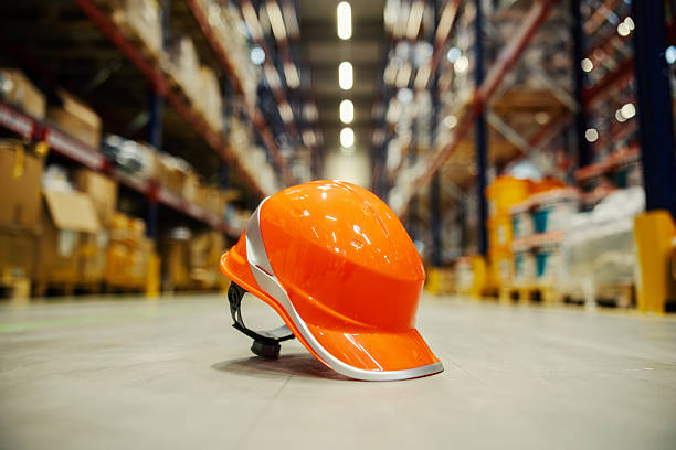 istock Orange safety hard hat in warehouse 2247764356