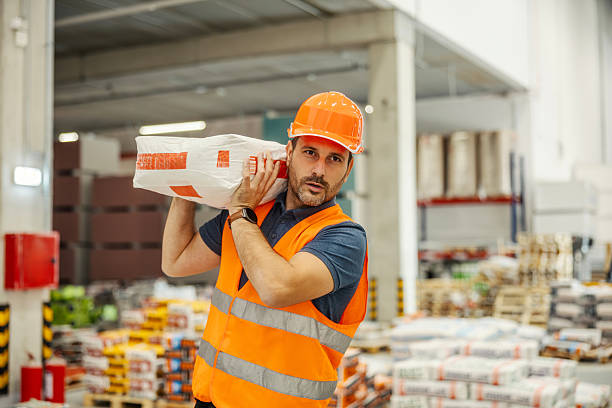 istock Warehouse worker carrying heavy bags on his shoulder 2247764605
