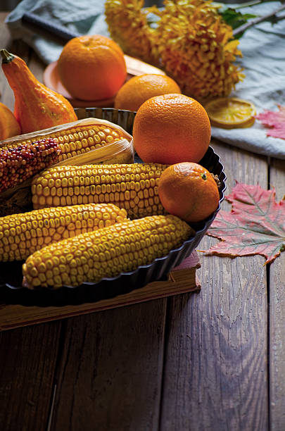 A bountiful flatlay capturing oranges and colorful heirloom corn in a rustic setting. Ideal for winter wellness, immune-boosting nutrition, and farm-to-table content, this image blends natural textures with seasonal abundance.