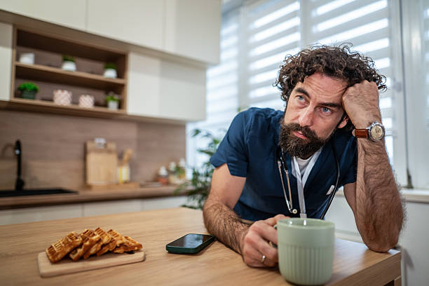 istock Overworked male doctor feeling stressed and tired after long shift 2247768932