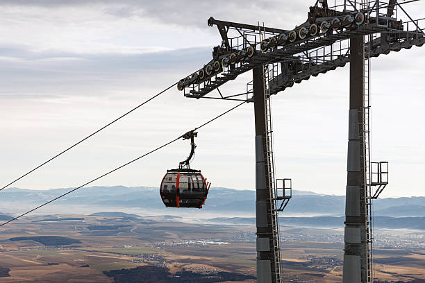 istock Single gondola cable car above winter valley landscape 2247775095