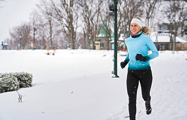 istock Nice Young Woman Running in Snowy Park 2247779171