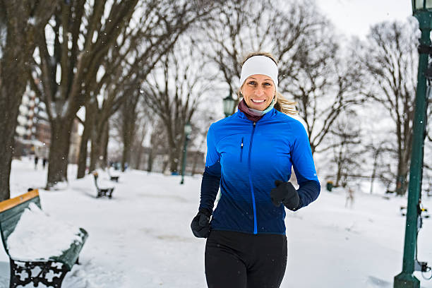 istock Nice Young Woman Running in Snowy Park 2247779292