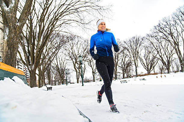 istock Nice Young Woman Running in Snowy Park 2247779298