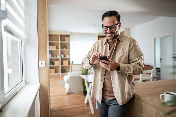 istock Smiling man using smartphone connecting to social media 2247780568