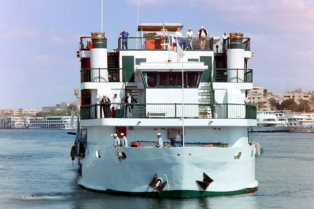 Aswan, Egypt - September, 21.1997: Docking maneuvers of a cruise ship. Please not taht the image were scanned from an old negative.