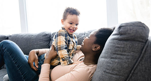 istock Mother and Son having fun on sofa Together 2247781783