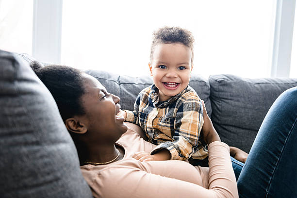 istock Mother and Son having fun on sofa Together 2247781788