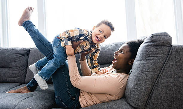 istock Mother and Son having fun on sofa Together 2247781793