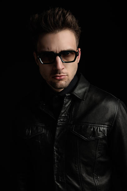 istock cool blonde man with sunglasses wearing black leather jacket 2247783239