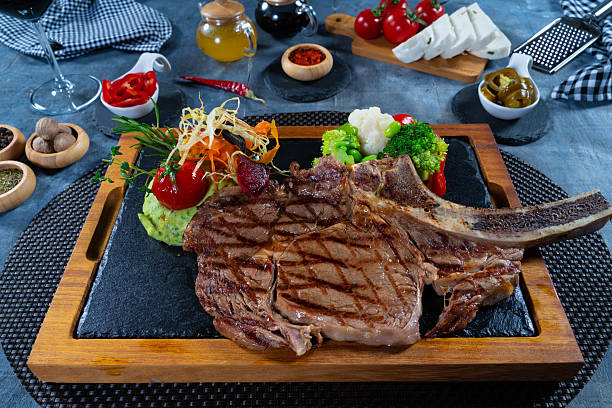 istock Grilled beef ribeye with vegetables and mashed potatoes on wooden plate 2247784272
