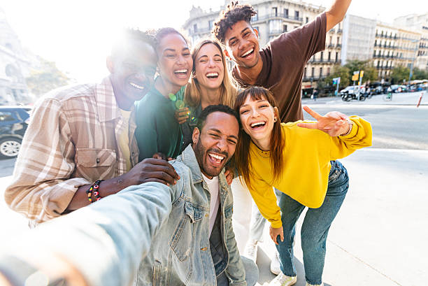 istock Multicultural cheerful friends taking selfie pic with smart mobile phone device - Youth community people laughing at camera together - Friendship concept with guys and girls having fun outdoors 2247785464