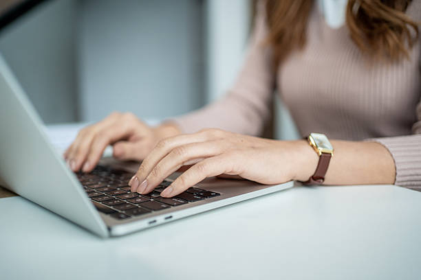 istock Woman's hands typing on laptop keyboard working from home 2247788501