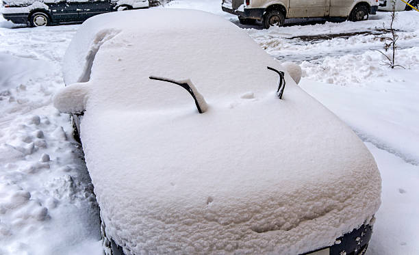 istock A car covered in snow on the side of a road 2247788902
