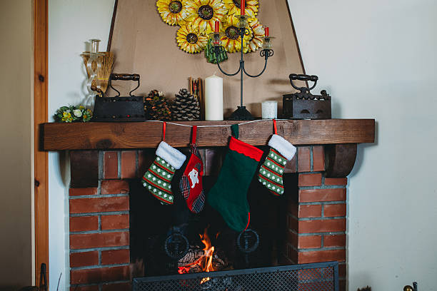 Holiday season fireplace. Warm, cozy, glowing Christmas holiday season scene, with blazing fire in fireplace.